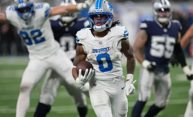 Detroit Lions running back Jahmyr Gibbs (0) runs for a touchdown against the Dallas Cowboys during the second half of an NFL football game Thursday, Dec. 4, 2025, in Detroit. (AP Photo/Paul Sancya)