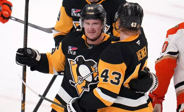 Pittsburgh Penguins' Noel Acciari (55) celebrates his goal during the first period of an NHL hockey game against the Anaheim Ducks in Pittsburgh, Tuesday, Dec. 9, 2025. (AP Photo/Gene J. Puskar)