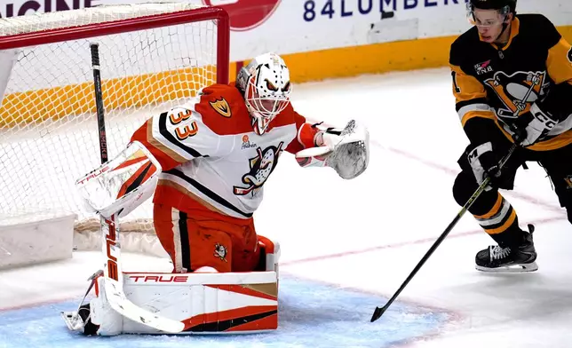 Anaheim Ducks goaltender Ville Husso (33) blocks a shot by Pittsburgh Penguins' Ben Kindel during the first period of an NHL hockey game, in Pittsburgh, Tuesday, Dec. 9, 2025. (AP Photo/Gene J. Puskar)
