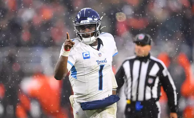 Tennessee Titans quarterback Cam Ward (1) celebrates after throwing a touchdown pass in the second half of an NFL football game against the Cleveland Browns in Cleveland, Sunday, Dec. 7, 2025. (AP Photo/David Richard)