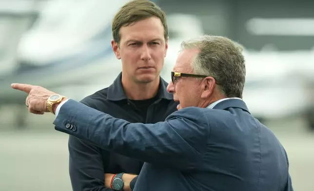 FILE - White House special envoy Steve Witkoff, right, and Jared Kushner wait for the arrival of President Donald Trump at Teterboro Airport in Teterboro, N.J., en route to attend the Club World Cup final soccer match, July 13, 2025. (AP Photo/Jacquelyn Martin, File)