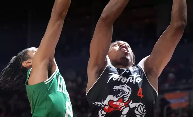 Toronto Raptors forward Scottie Barnes (4) tries for a layup as Boston Celtics forward Josh Minott (8) tries to block him out during first-half NBA basketball game action in Toronto, Sunday Dec. 7, 2025. (Chris Young/The Canadian Press via AP)