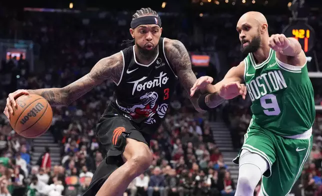 Toronto Raptors forward Brandon Ingram (3) drives against Boston Celtics guard Derrick White (9) during first-half NBA basketball game action in Toronto, Sunday Dec. 7, 2025. (Chris Young/The Canadian Press via AP)