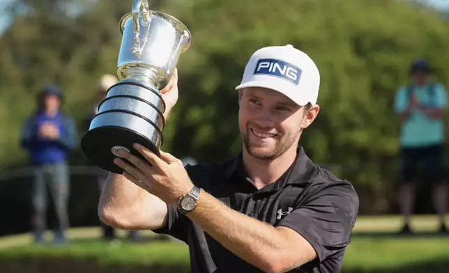 Denmark's Rasmus Neergaard-Petersen holds the Stonehaven Cup after winning the Australian Open golf tournament in Melbourne, Australia, Sunday, Dec. 7, 2025. (AP Photo/Asanka Brendon Ratnayake)