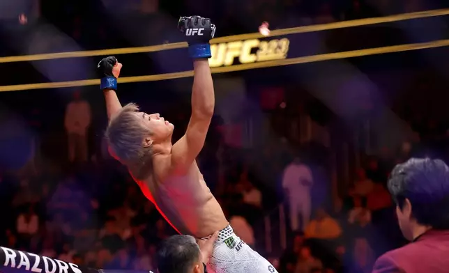 Tatsuro Taira, of Japan, celebrates after defeating Brandon Moreno in a flyweight bout during UFC 323 Saturday, Dec. 6, 2025, in Las Vegas. (Steve Marcus/Las Vegas Sun via AP)