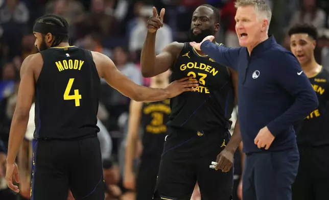 Golden State Warriors forward Draymond Green (23) gestures toward a referee after being ejected as Moses Moody (4) restrains him during the first half of an NBA basketball game against the Phoenix Suns in San Francisco, Saturday, Dec. 20, 2025. (AP Photo/Jed Jacobsohn)