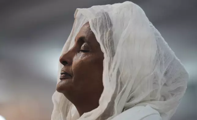 A congregant of the Re'ese Adbarat Debre Selam Kidist Mariam Church, an Ethiopian Orthodox Tewahedo church, stands during a service, in Washington, D.C., April 5, 2025. (AP Photo/Jessie Wardarski, File)