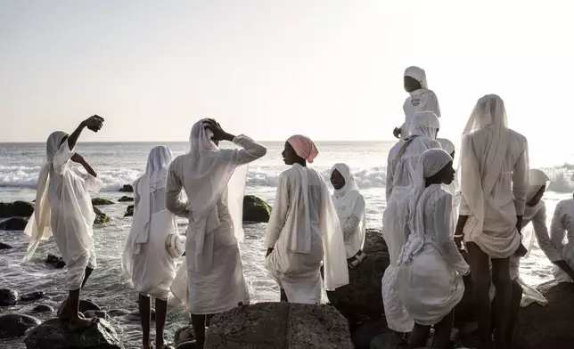 Followers from the Layene brotherhood gather near a sacred grotto where they believe their prophet received divine inspiration, in Ngor, Senegal, Jan. 30, 2025. (AP Photo/Annika Hammerschlag, File)