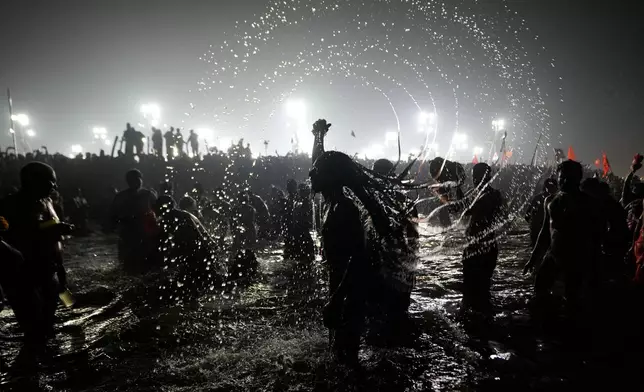 Naga Sadhus or Naked Hindu holy men take a bath at the Sangam, the confluence of three sacred rivers the Yamuna, the Ganges and the mythical Saraswati, on Vasant Panchami, during the Kumbh Mela in Prayagraj, Uttar Pradesh state, India, Feb. 3, 2025. (AP Photo/Channi Anand, File)