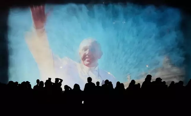 A portrait of the late Pope Francis is projected onto a water fountain at Magic Water Circuit, in Lima, Peru, April 21, 2025. (AP Photo/Martin Mejia, File)