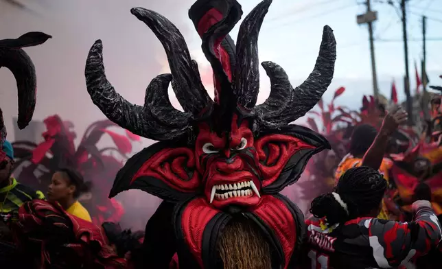 Revelers take part in the Devils and Congos Festival, in Portobelo, Panama, May 3, 2025. (AP Photo/Matias Delacroix, File)