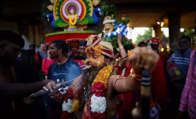 A Tamil Hindu priest takes part in a procession during the Thaipusam festival at Batu Caves, on the outskirts of Kuala Lumpur, Malaysia, Feb. 11, 2025. (AP Photo/Vincent Thian, File)