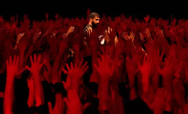 Iranian Shiite Muslims mourn in a ceremony on the eve of Ashoura, the death anniversary of Prophet Muhammad's grandson, Hussein, in Tehran Iran, July 5, 2025, (AP Photo/Vahid Salemi, File)
