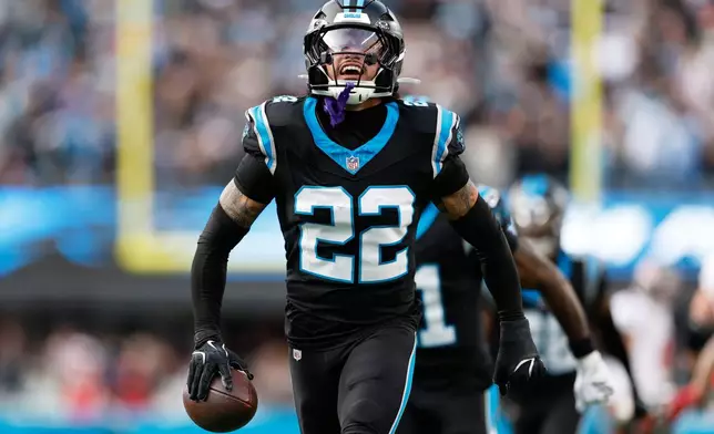 Carolina Panthers safety Lathan Ransom celebrates after and interception against the Tampa Bay Buccaneers during the second half of an NFL football game, Sunday, Dec. 21, 2025, in Charlotte, N.C. (AP Photo/Rusty Jones)