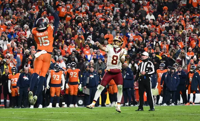 Denver Broncos outside linebacker Nik Bonitto (15) blocks a pass attempt by Washington Commanders quarterback Marcus Mariota (8) on a failed two-point conversion attempt in overtime of an NFL football game Monday, Dec. 1, 2025, in Landover, Md. (AP Photo/Nick Wass)
