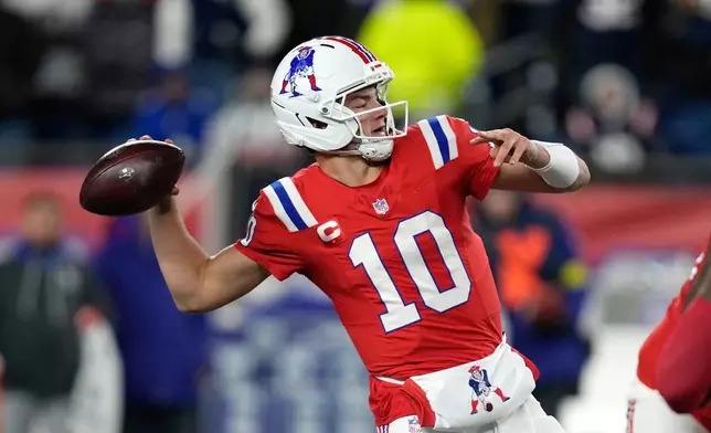 New England Patriots quarterback Drake Maye looks to pass against the New York Giants during the first half of an NFL football game Monday, Dec. 1, 2025, in Foxborough, Mass. (AP Photo/Charles Krupa)