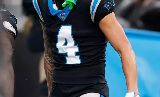 Carolina Panthers wide receiver Tetairoa McMillan celebrates after scoring against the Los Angeles Rams during the second half of an NFL football game, Sunday, Nov. 30, 2025, in Charlotte, N.C. (AP Photo/Rusty Jones)