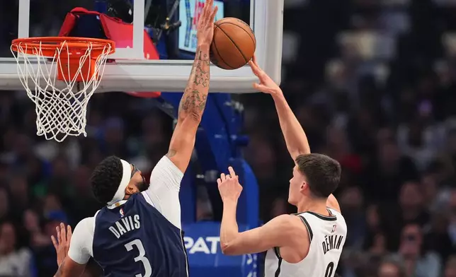 Dallas Mavericks forward Anthony Davis (3) blocks a shot attempt by Brooklyn Nets guard Egor Demin (8) in the first half of an NBA basketball game in Dallas, Friday, Dec. 12, 2025. (AP Photo/Tony Gutierrez)