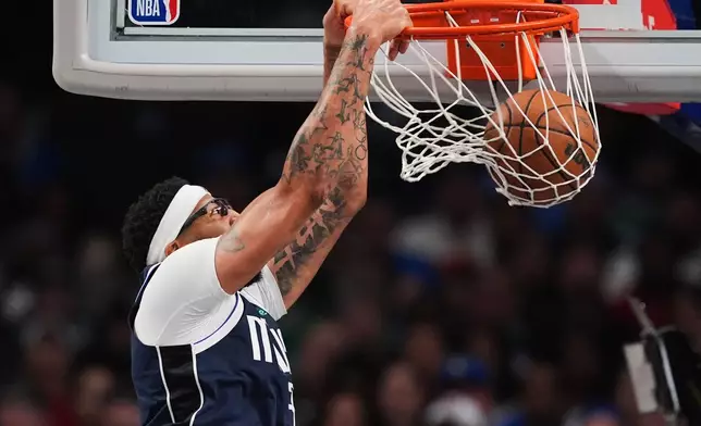 Dallas Mavericks forward Anthony Davis dunks in the second half of an NBA basketball game against the Brooklyn Nets in Dallas, Friday, Dec. 12, 2025. (AP Photo/Tony Gutierrez)