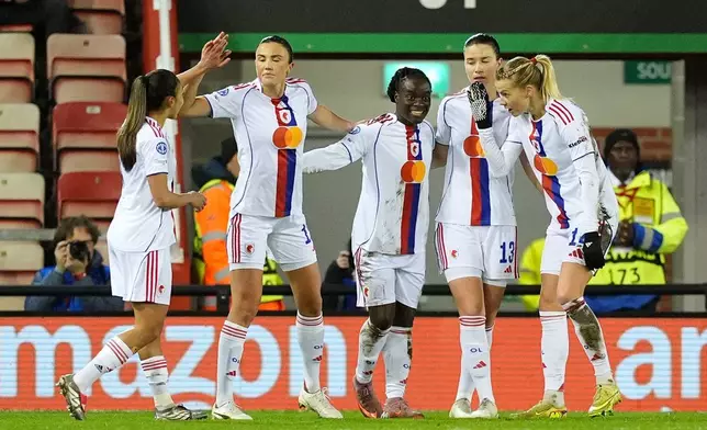 OL Lyonnes' Tabitha Chawinga, center, celebrates with teammates after scoring their side's first goal during a women's Champions League soccer match against Manchester United, Wednesday, Dec. 10, 2025, in Leigh, England. (Martin Rickett/PA via AP)