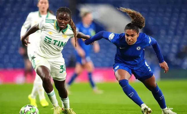 Roma's Omorinsola Babajide, left, and Chelsea's Catarina Macario in action during the Women's Champions League soccer match between Chelsea and Roma at Stamford Bridge, London, Wednesday Dec. 10, 2025. (Adam Davy/PA via AP)