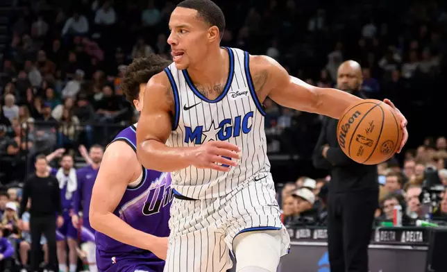 Orlando Magic guard Desmond Bane, front, dribbles past the defense of Utah Jazz guard Walter Clayton Jr., rear, during an NBA basketball game, Saturday, Dec. 20, 2025, in Salt Lake City. (AP Photo/Tyler Tate)