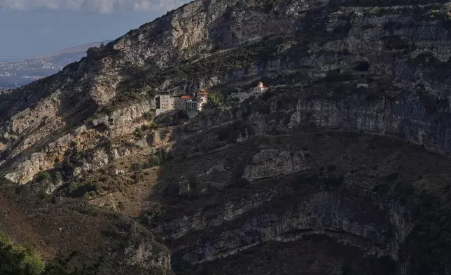 The Hamatoura Monastery, one of several monastic communities built into the cliffs of the scenic Qadisha Valley, a site considered sacred by Lebanon's Maronite Christians, is seen above the northeastern mountain town of Kousba, Lebanon, Saturday, Nov. 15, 2025. (AP Photo/Hassan Ammar)