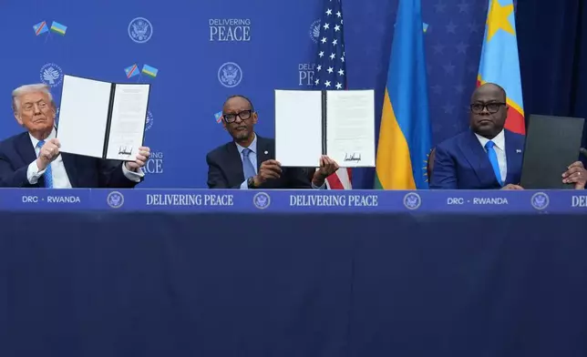 President Donald Trump, Rwanda's President Paul Kagame and Democratic Republic of Congo President Felix-Antoine Tshisekedi, during a signing ceremony at the Donald J. Trump Institute of Peace, Thursday, Dec. 4, 2025, in Washington. (AP Photo/Evan Vucci)
