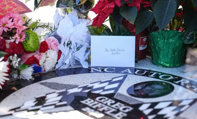 Flowers and cards are displayed at the NC Auto Racing Walk of Fame for Greg Biffle, Friday, Dec. 19, 2025, in Mooresville, N.C. (AP Photo/Matt Kelley)