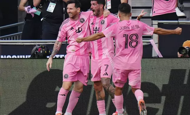 Inter Miami's Rodrigo de Paul (centre) celebrates his goal against the Vancouver Whitecaps with Lionel Messi (left) and Jordi Alba during the second half of the MLS Cup final soccer match, in Fort Lauderdale, Fla., on Saturday, Dec. 6, 2025. (Darryl Dyck/The Canadian Press via AP)