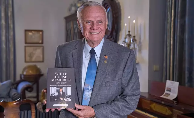 Former White House chief usher Gary Walters, author of "White House Memories," holds his book for a portrait, in Washington, Thursday, Dec. 4, 2025. (AP Photo/Jacquelyn Martin)