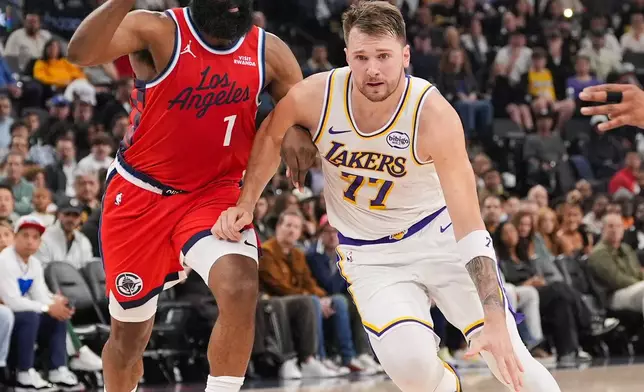 Los Angeles Clippers guard James Harden (1) pressures Los Angeles Lakers forward/guard Luka Doncic (77) during the first half of an NBA basketball game Saturday, Dec. 20, 2025, in Inglewood, Calif. (AP Photo/Jae C. Hong)