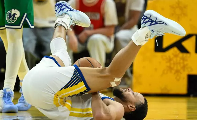 Golden State Warriors guard Stephen Curry reacts after getting fouled by the Dallas Mavericks during the first half of an NBA basketball game, Thursday, Dec. 25, 2025, in San Francisco. (AP Photo/Eakin Howard)