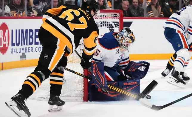 Edmonton Oilers goaltender Tristan Jarry blocks a shot by Pittsburgh Penguins' Rickard Rakell (67) during the second period of an NHL hockey game in Pittsburgh, Tuesday, Dec. 16, 2025. (AP Photo/Gene J. Puskar)