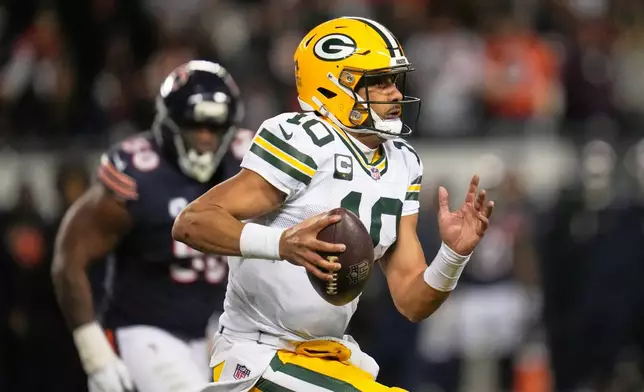 Green Bay Packers' Jordan Love scrambles during the first half of an NFL football game against the Chicago Bears Saturday, Dec. 20, 2025, in Chicago. (AP Photo/Erin Hooley)