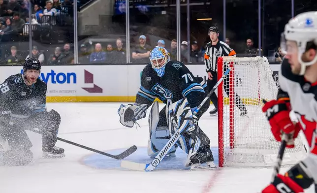 Utah Mammoth goaltender Karel Vejmelka (70) protects the net during the second period of an NHL hockey game against the New Jersey Devils, Friday, Dec. 19, 2025, in Salt Lake City. (AP Photo/Tyler Tate)