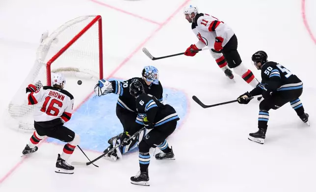New Jersey Devils right wing Stefan Noesen scores a goal past Utah Mammoth goaltender Karel Vejmelka (70) during the third period of an NHL hockey game, Friday, Dec. 19, 2025, in Salt Lake City. (AP Photo/Tyler Tate)