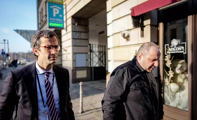 Günter Sautter, left, foreign and security policy advisor to the Federal Chancellor, and former Ukrainian Defense Minister Rustem Umjerow arrive for talks between representatives of the U.S. and Ukraine, at the Hotel Adlon, in Berlin, Sunday, Dec. 14, 2025. (Kay Nietfeld/dpa via AP)