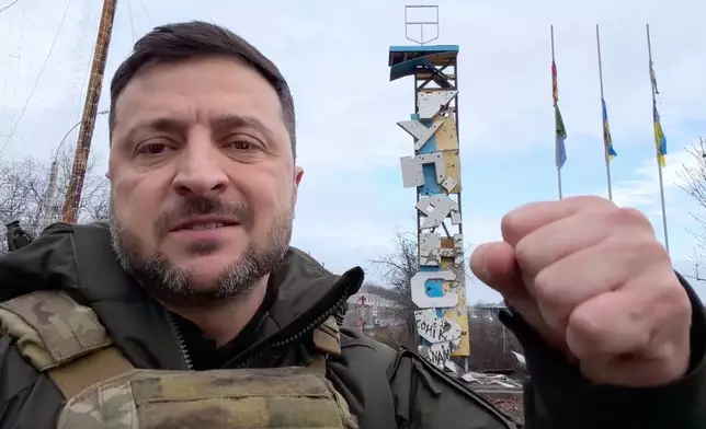 In this grab from a video provided by the Press Service Of The President Of Ukraine on Friday, Dec 12, 2025, Ukraine's President Volodymyr Zelenskyy records a video at the road entering of Kupiansk, Ukraine. (Press Service Of The President Of Ukraine via AP)