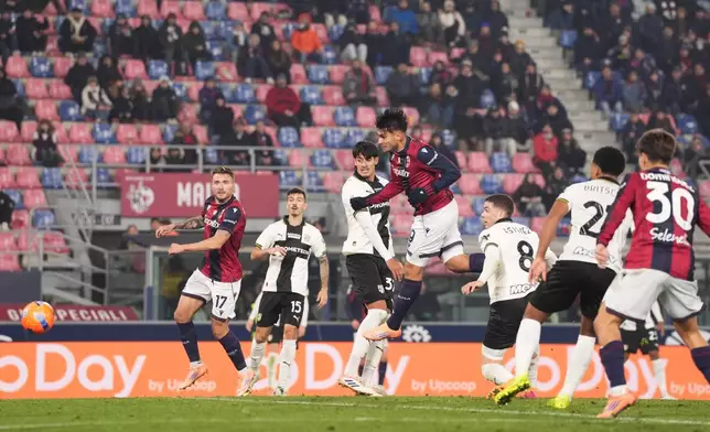 Bologna's Santiago Castro, center, scores his side's second goal during the Italian Cup soccer match between Bologna and Parma in Bologna, Italy, Thursday, Dec. 4, 2025. (Massimo Paolone/LaPresse via AP)