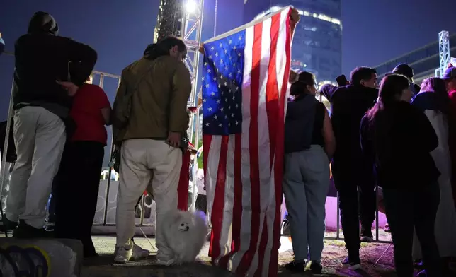 Supporters listen to Presidential candidate Jose Antonio Kast, of the opposition Republican Party, delivering his victory speech after winning the presidential runoff election in Santiago, Chile, Sunday, Dec. 14, 2025. (AP Photo/Natacha Pisarenko)