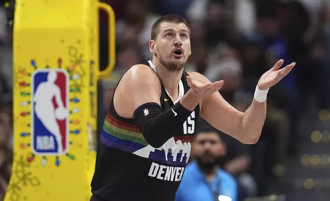Denver Nuggets center Nikola Jokić reacts after he was called for a foul against the Minnesota Timberwolves in the first half of an NBA basketball game Thursday, Dec. 25, 2025, in Denver. (AP Photo/David Zalubowski)