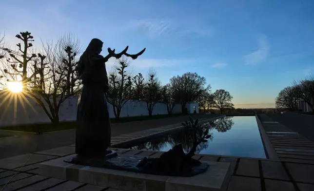 ***HOLD FOR STORY BY MOLLY QUELL SLUGGED NETHERLANDS BLACK LIBERATORS*** The sun sets over the Netherlands American Cemetery in Margraten, Netherlands, Thursday, Dec. 11, 2025, where the American Battle Monuments Commission removed two displays honoring Black liberators from the visitors center. (AP Photo/Peter Dejong)