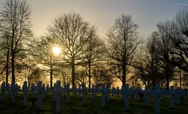 ***HOLD FOR STORY BY MOLLY QUELL SLUGGED NETHERLANDS BLACK LIBERATORS*** The sun sets over the graves of more than 8.300 WWII soldiers at the Netherlands American Cemetery in Margraten, Netherlands, Thursday, Dec. 11, 2025, where the American Battle Monuments Commission removed two displays honoring Black liberators from the visitors center. (AP Photo/Peter Dejong)