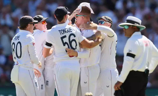 England's Zak Crawley celebrates catching Australia's Travis Head during play on day one of the third Ashes cricket test between England and Australia at the Adelaide Oval in Adelaide, Australia, Wednesday, Dec. 17, 2025. (AP Photo/James Elsby)