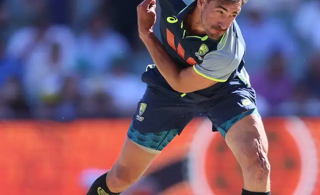 Australia's Mitchell Starc warms up during play on day one of the third Ashes cricket test between England and Australia at the Adelaide Oval, in Adelaide, Australia, Wednesday, Dec. 17, 2025. (AP Photo/James Elsby)