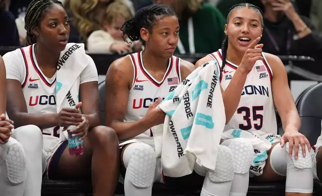 UConn's Azzi Fudd, right, talks with teammates KK Arnold, center, and Sarah Strong, left, during the second half of an NCAA college basketball game against Iowa Saturday, Dec. 20, 2025, in New York. (AP Photo/Frank Franklin II)