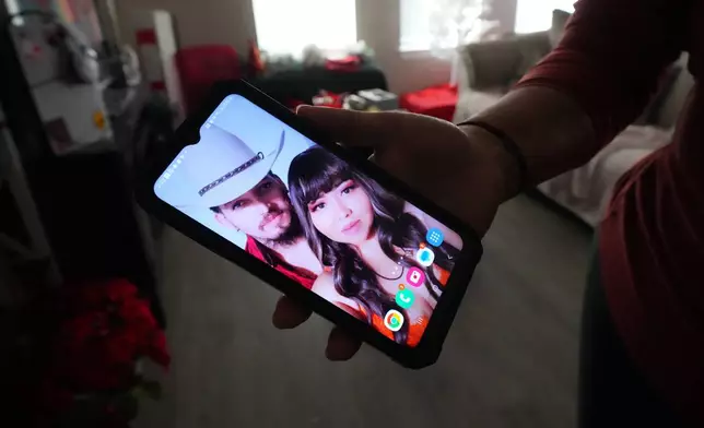 Cristina Osornio shows a photo, Nov. 18, 2025, in Rogers, Ark., of her and her husband, Edwin Sanchez-Mendoza, who signed deportation papers after being held in an immigration detention center for several months. (AP Photo/Julio Cortez)