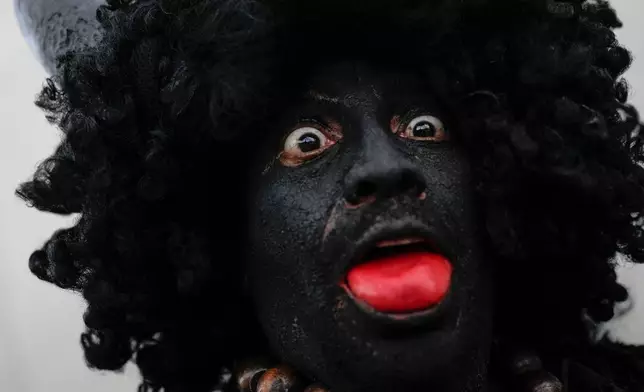 Revelers take part in the centuries-old Afro-Venezuelan Holy Innocents celebration in Caucagua, Venezuela, Sunday, Dec. 28, 2025. (AP Photo/Matias Delacroix)