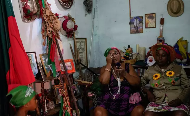 Revelers prepare to take part in the centuries-old Afro-Venezuelan Holy Innocents celebration in Caucagua, Venezuela, Sunday, Dec. 28, 2025. (AP Photo/Matias Delacroix)